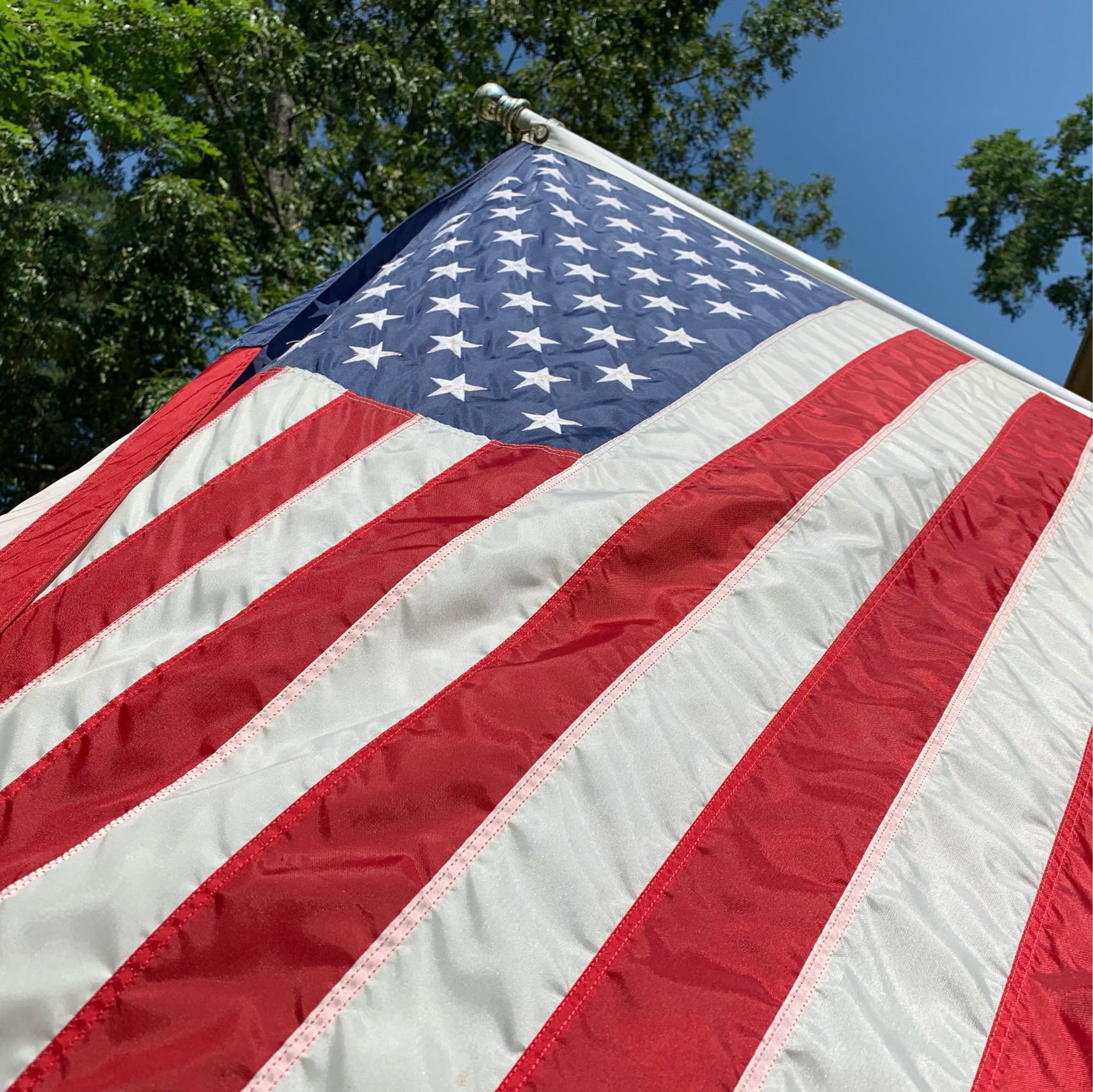 American flag fluttering in the wind on a sun soaked day