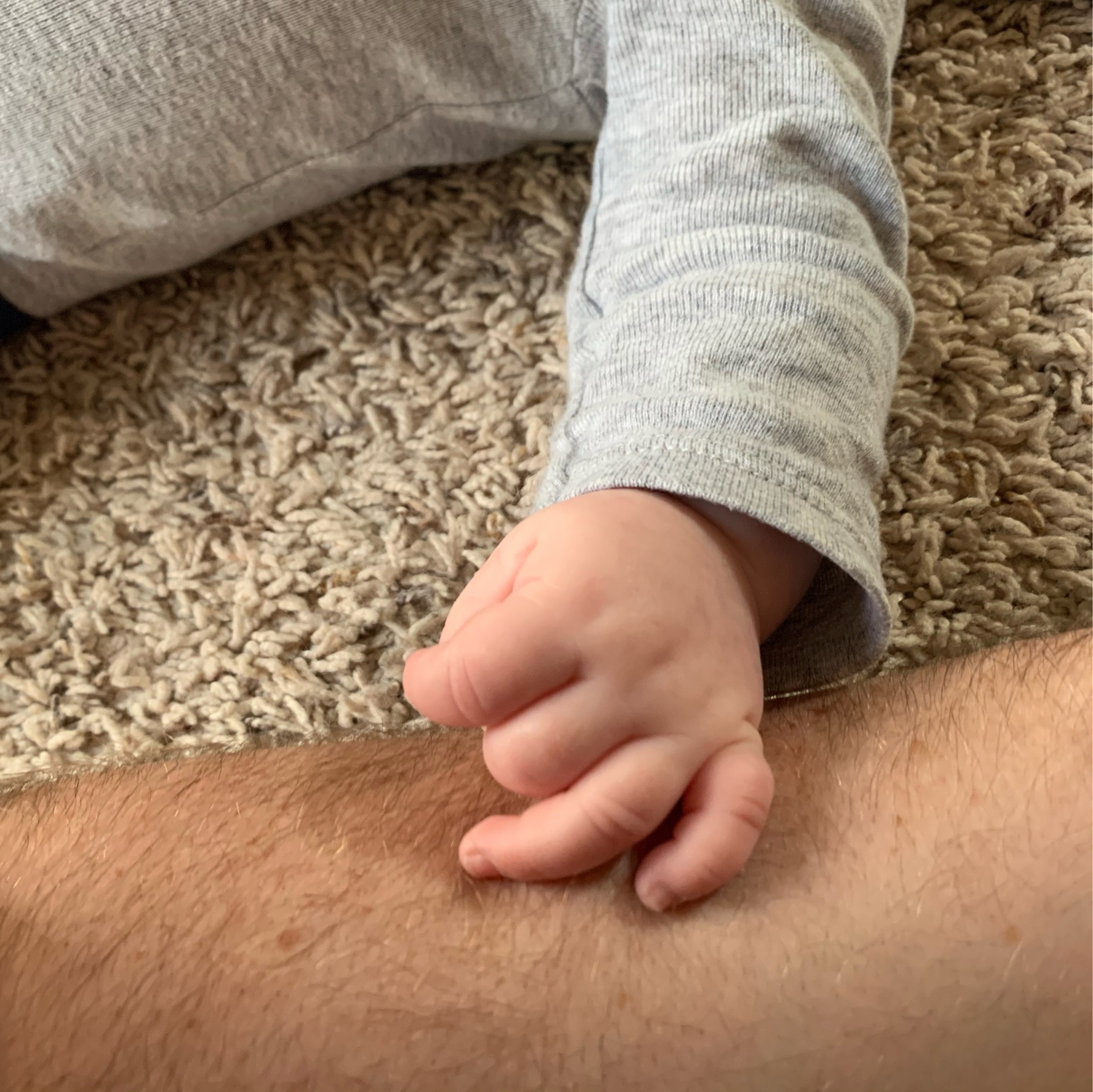Little hand rests on Dad's arm