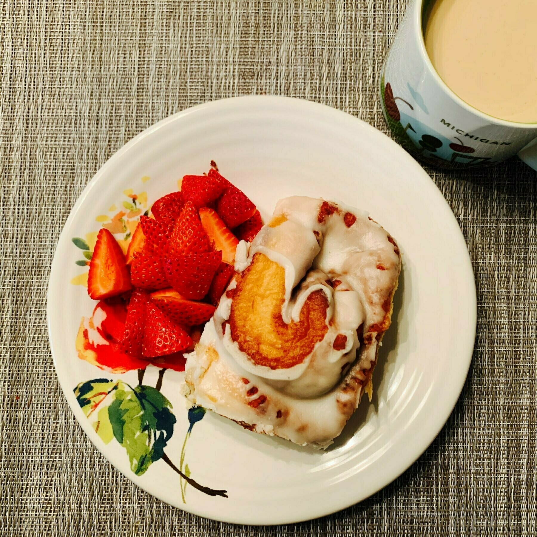 Cinnamon roll, strawberries, and coffee