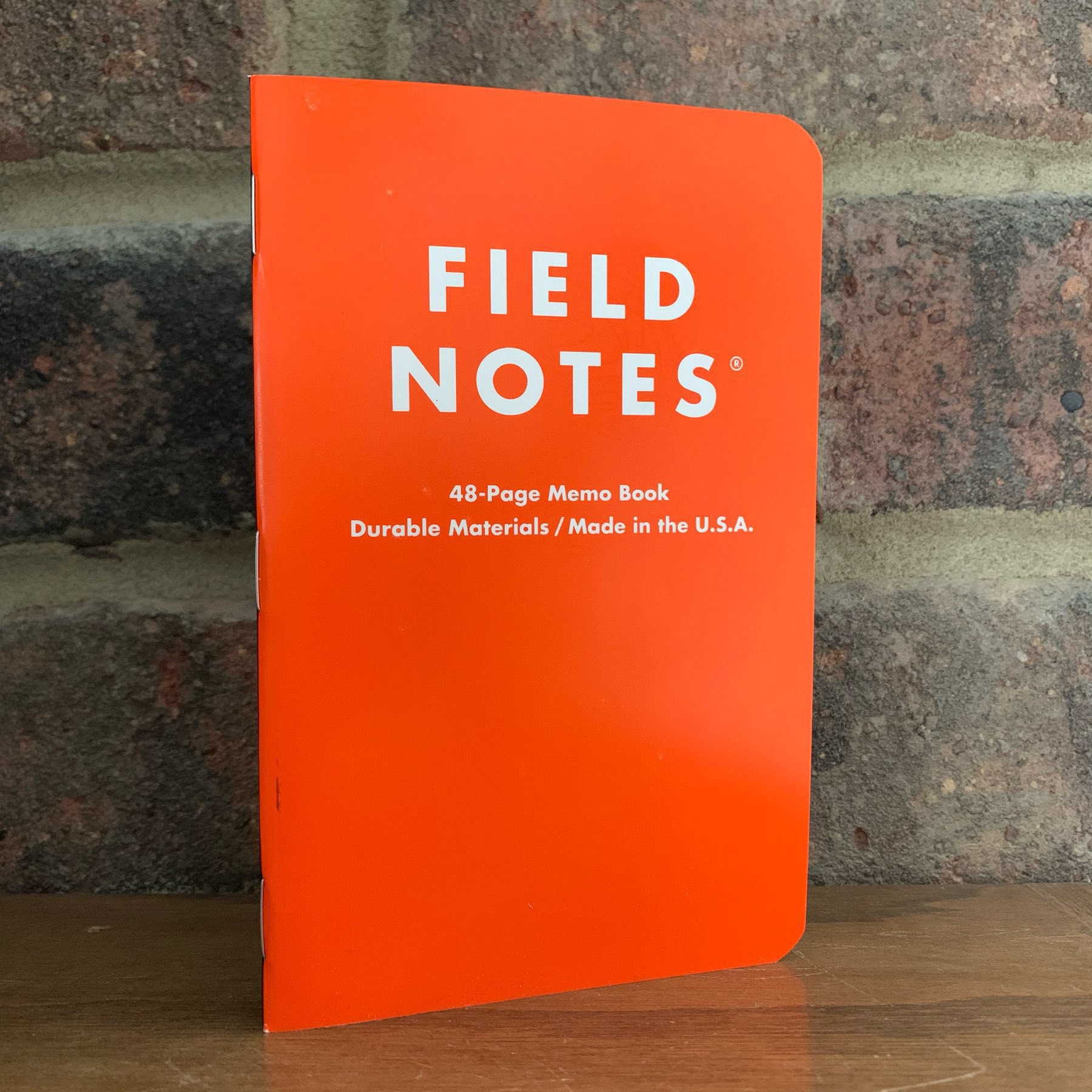 Orange cover on Field Notes notebook.