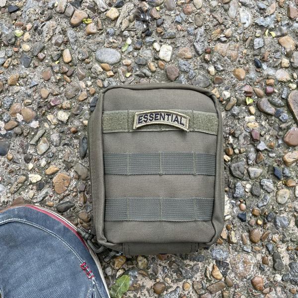 EDC Toolkit in pouch, on ground