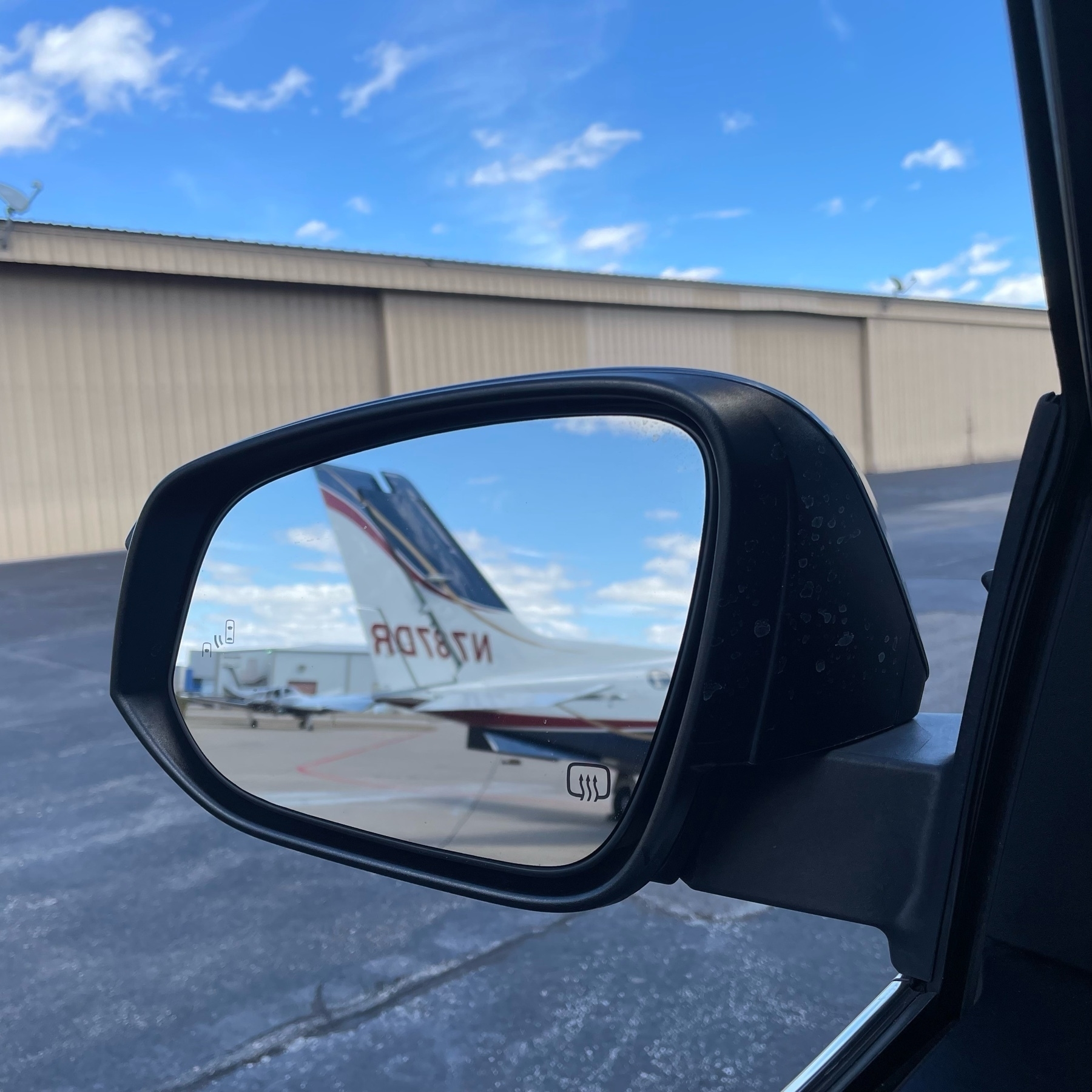 Airplanes on ramp in rearview mirror