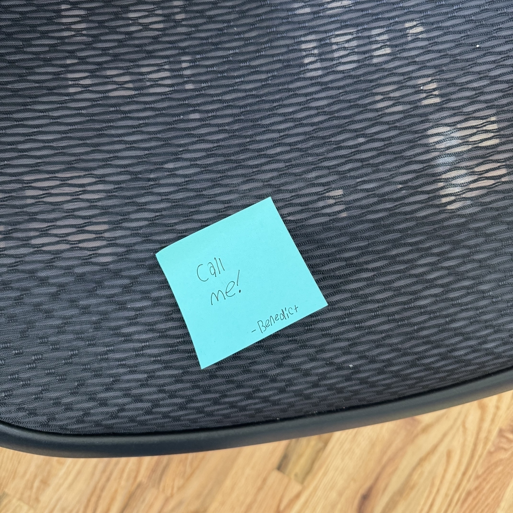 Sticky note on a desk chair. 