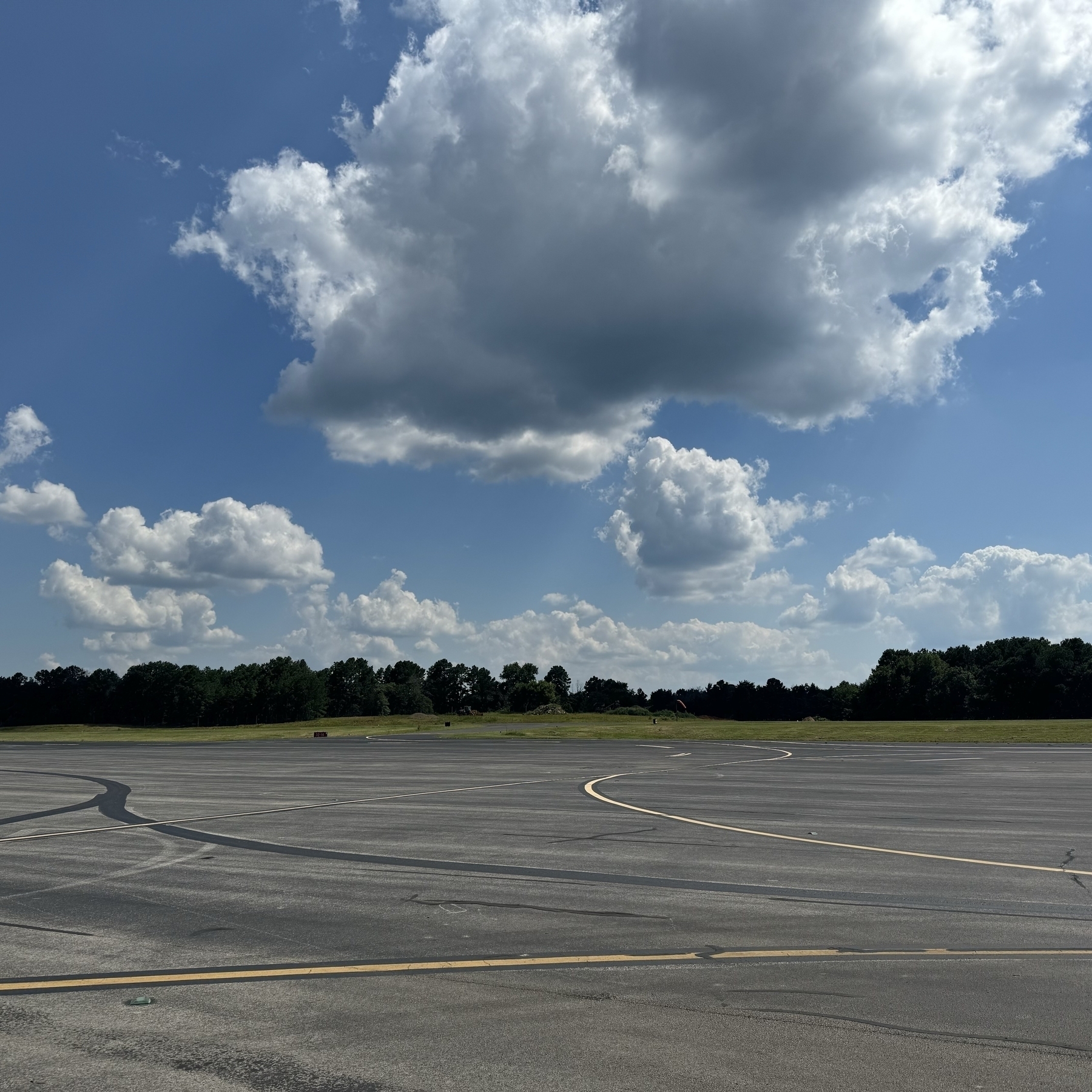 Empty airport ramp under partly cloudy skies