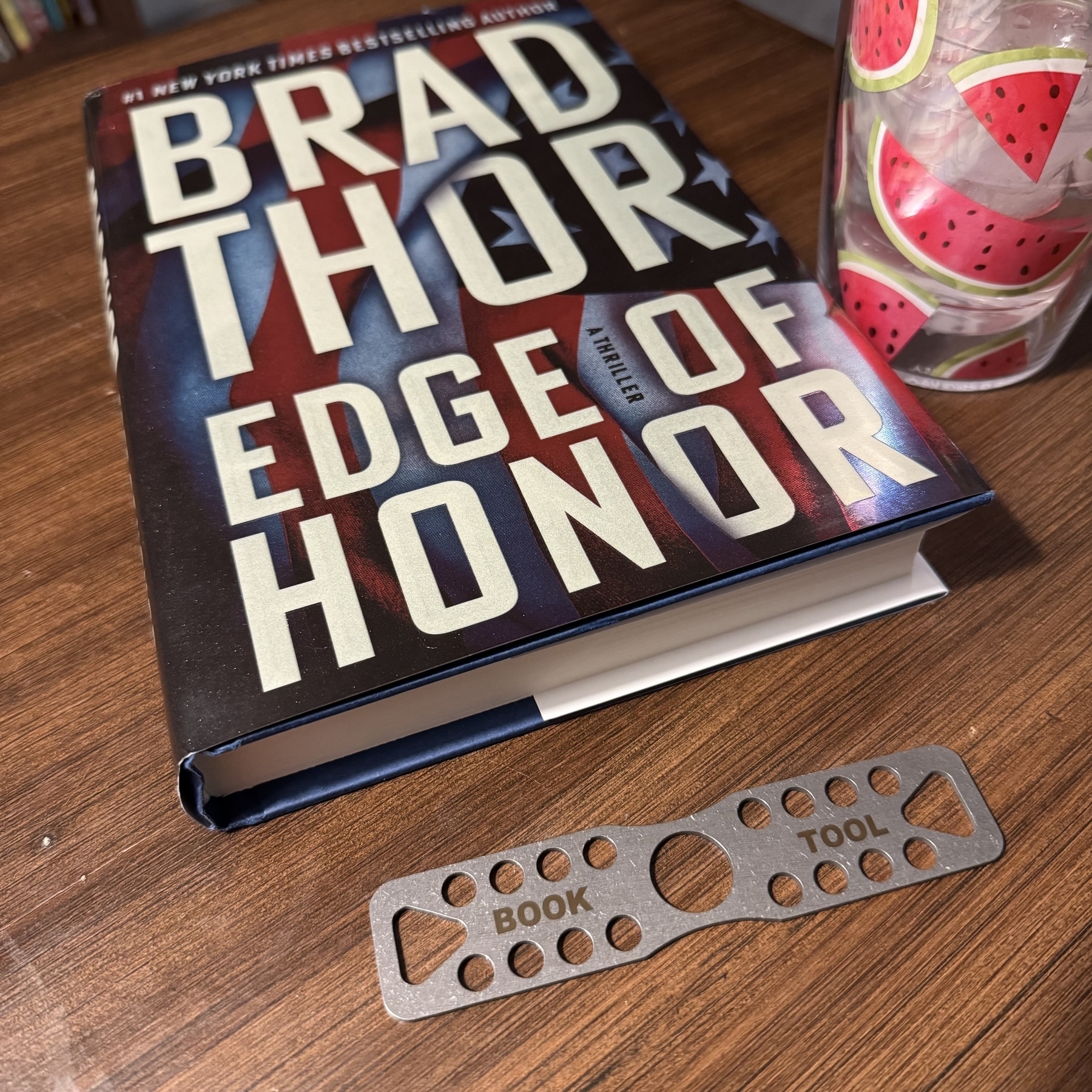 Book, bookmark, and drink on an end table