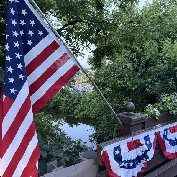 American flag and bunting on a bridge