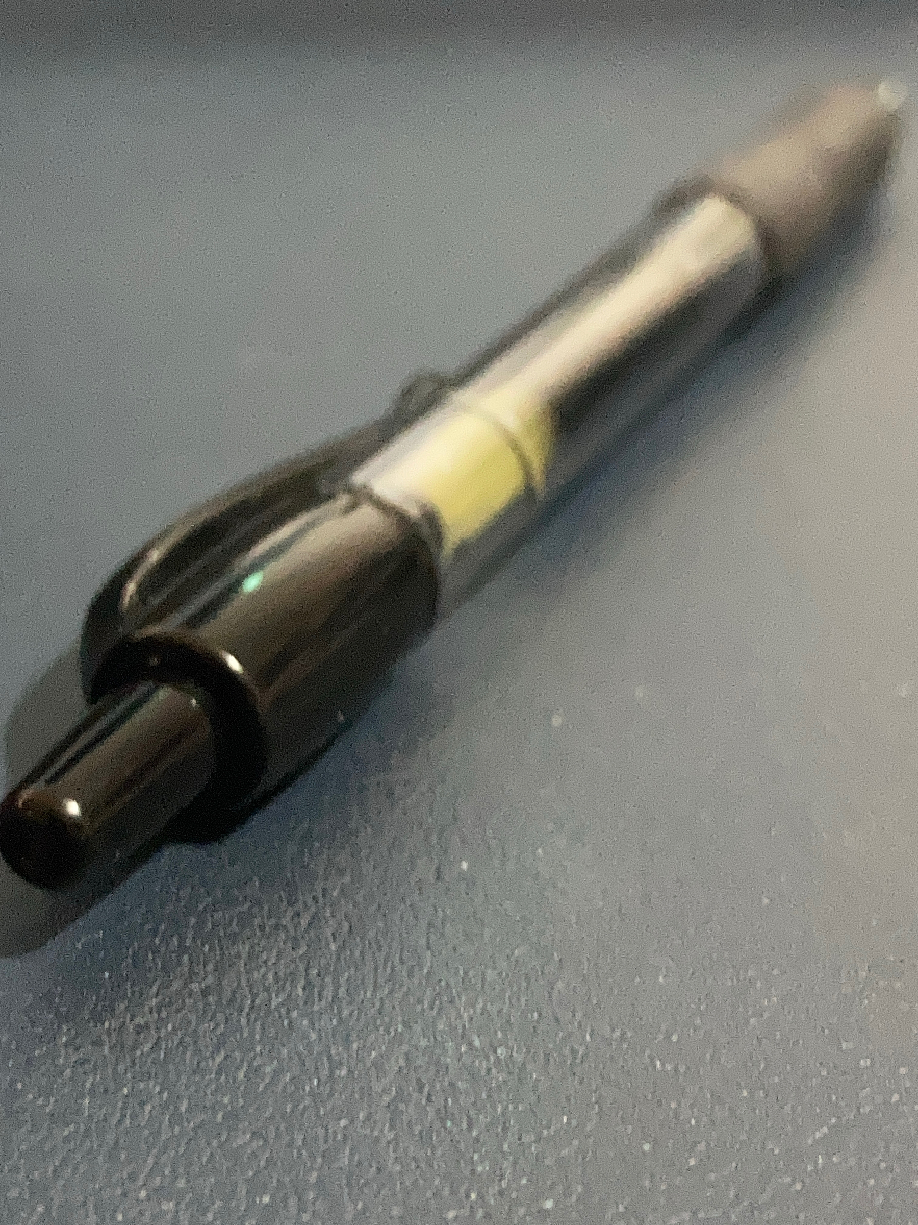 Close photo of a pen — the Pilot G-2 07 — atop a desk.