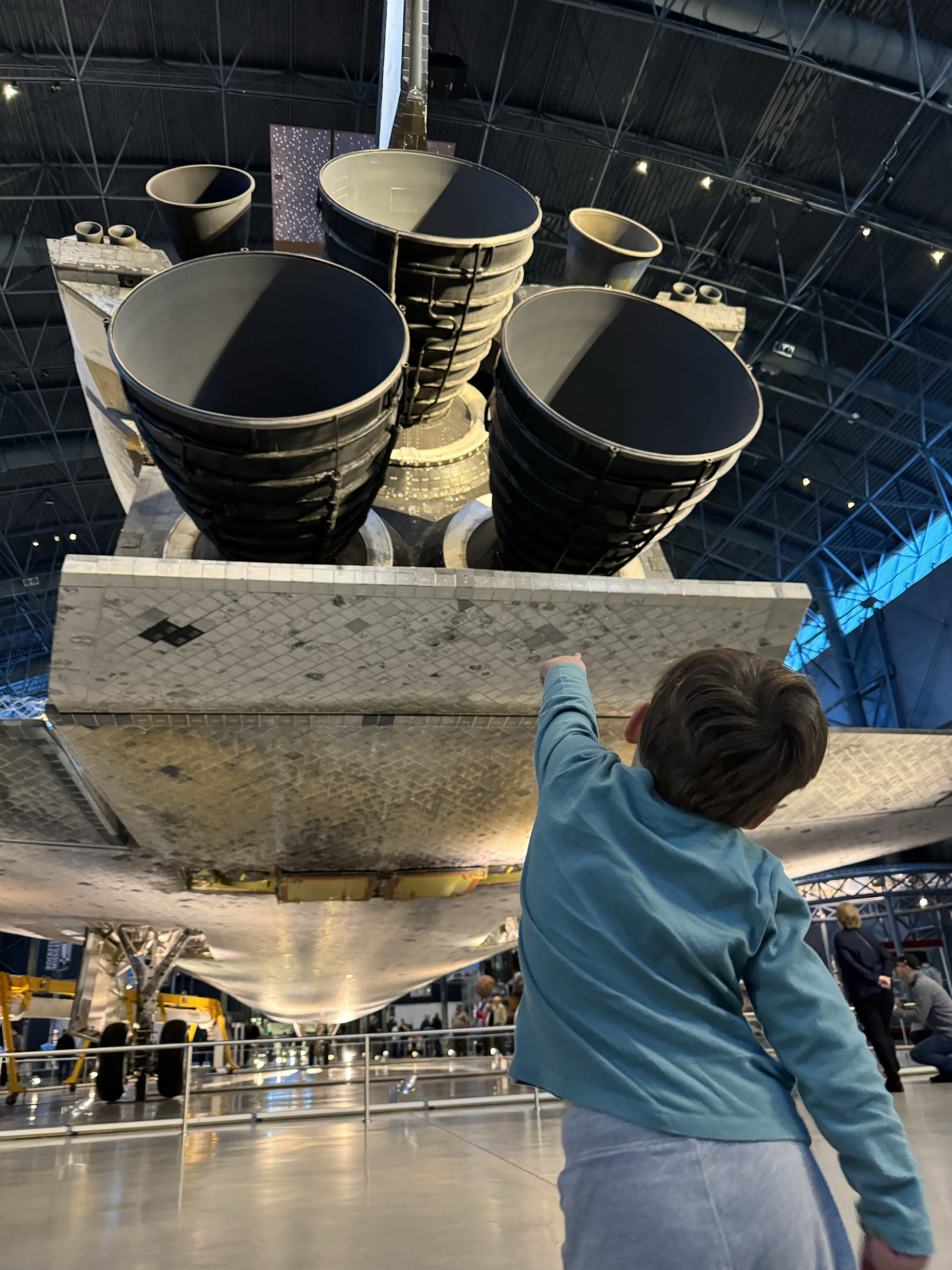 Jude pointing up at the space shuttle Discovery