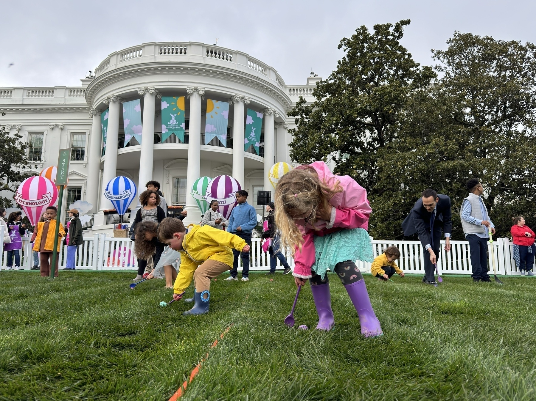 Vale and Jude rolling Easter eggs on the White House lawn