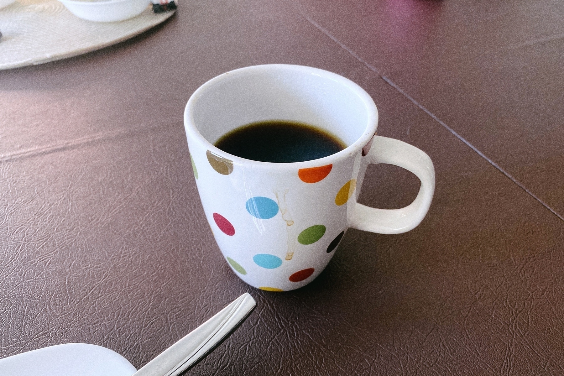 a half full coffee cup, photo taken with Stops.app