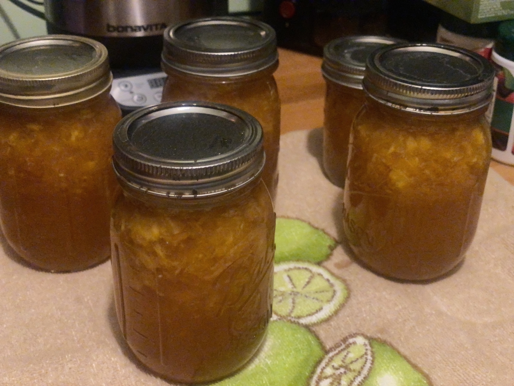 Jars of peach jam fresh out of the canner.