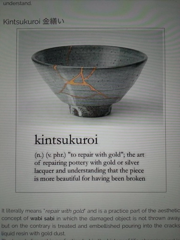 A ceramic bowl repaired with gold lacquer showcases the concept of kintsukuroi, emphasizing beauty in repaired pottery.