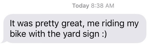 A text message from the author’s wife that reads, ‘It was pretty great, me riding my bike with the yard sign’