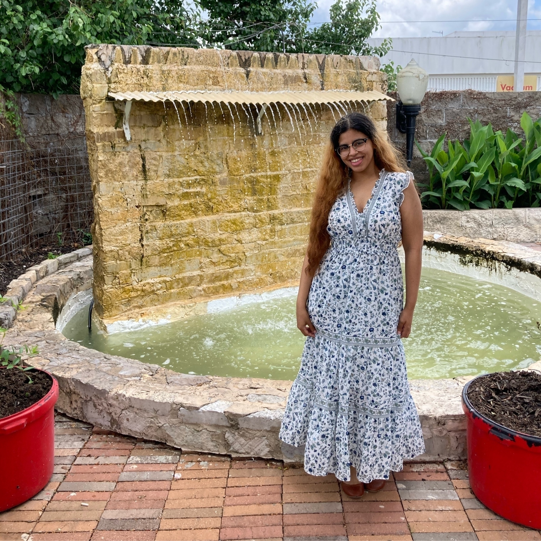 Me in a dress standing in front of a waterfall