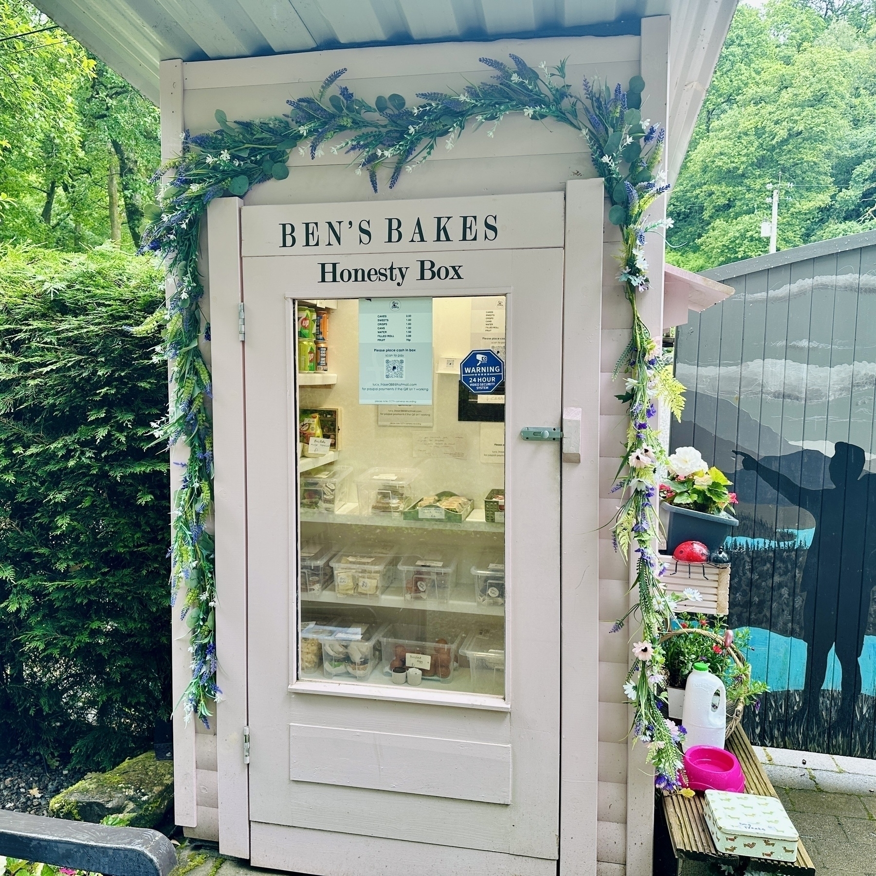 An honesty box containing sweets and other hiking supplies.