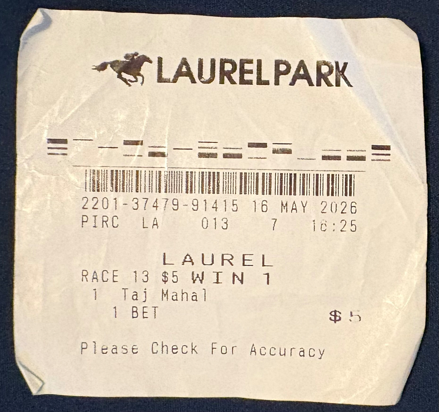 Auto-generated description: A $5 winning bet ticket for race 13 at Laurel Park on a horse named Taj Mahal is shown.