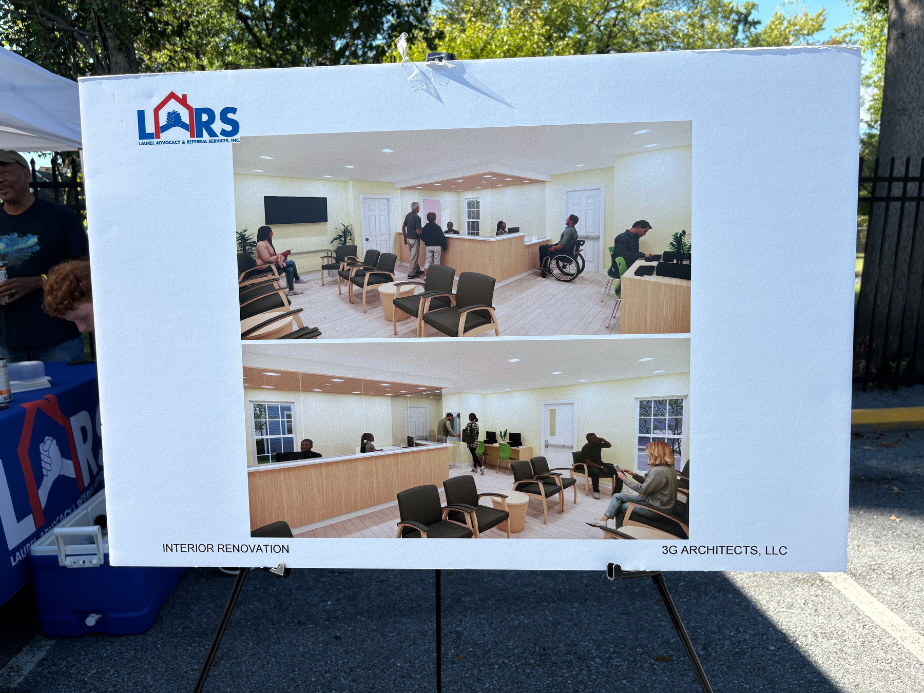 Auto-generated description: A presentation board displays architectural renderings of a renovated interior waiting area with seating and a reception desk by LARS and 3G Architects, LLC.