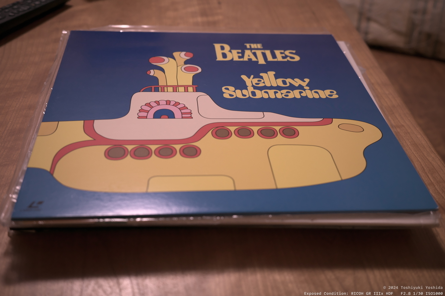 An album cover features a stylized yellow submarine with 