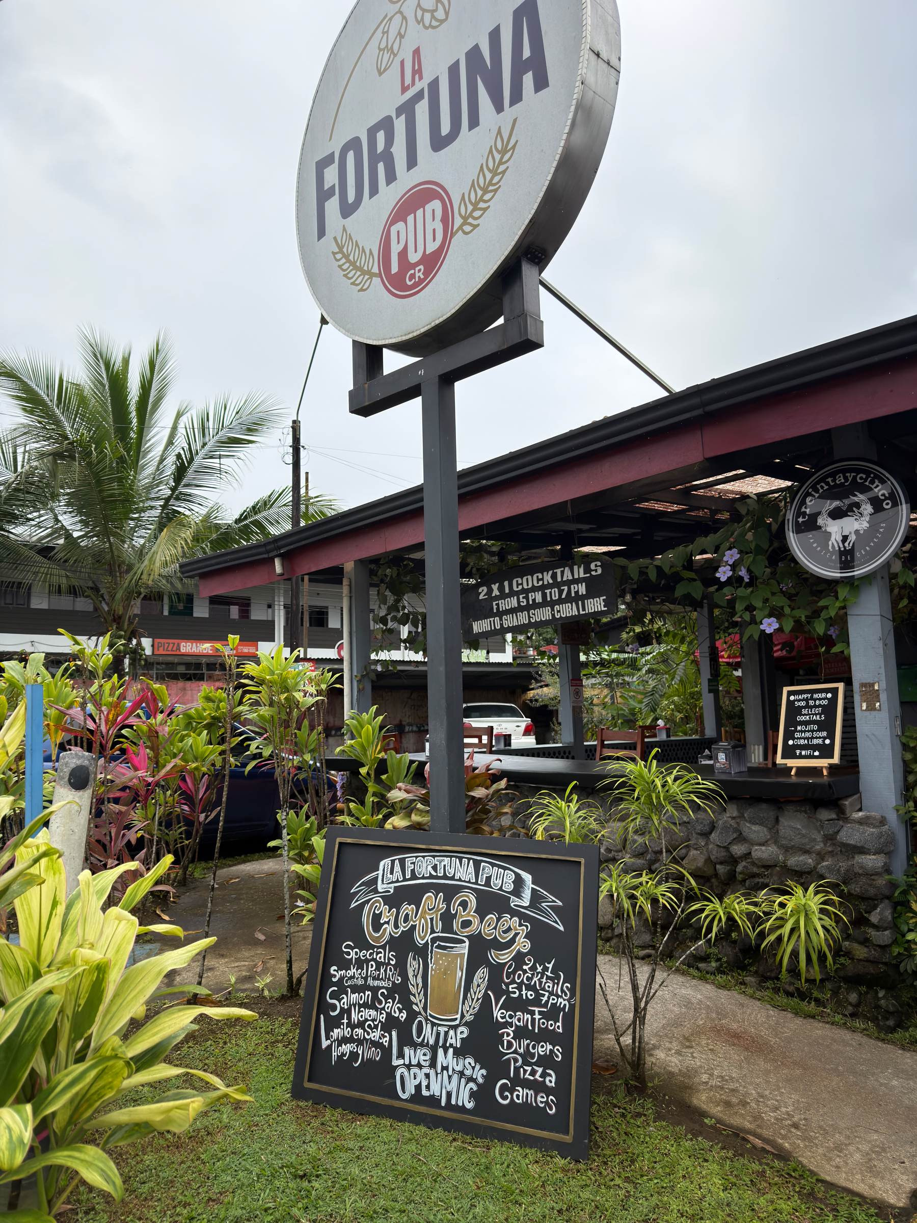 Auto-generated description: A pub named La Fortuna features outdoor signage promoting cocktails, live music, and special events.