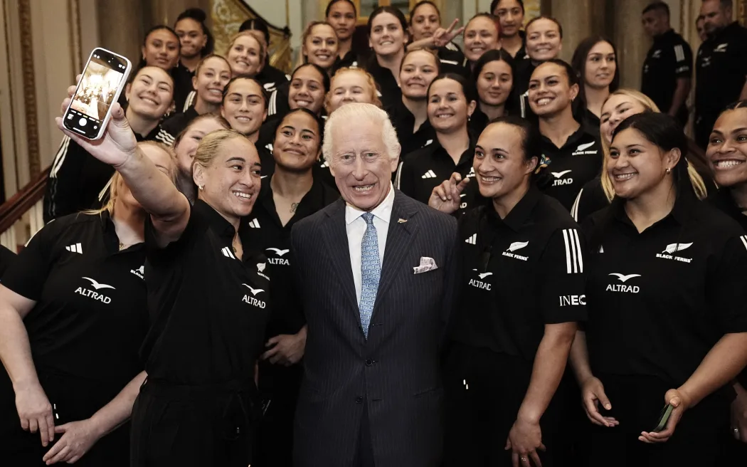 King Charles in a group hug with the New Zealand Black Ferns rugby team