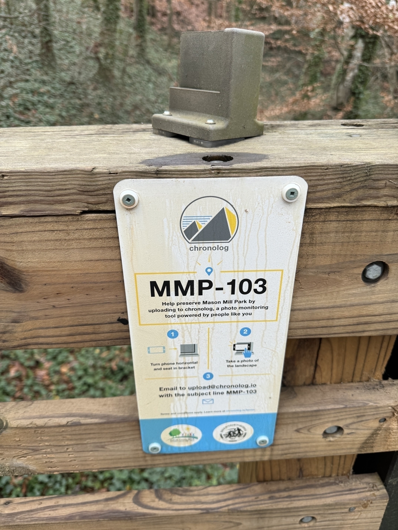A sign with the ID MMP-103 and instructions for how to take a photo and email to uploads@chronolog.io