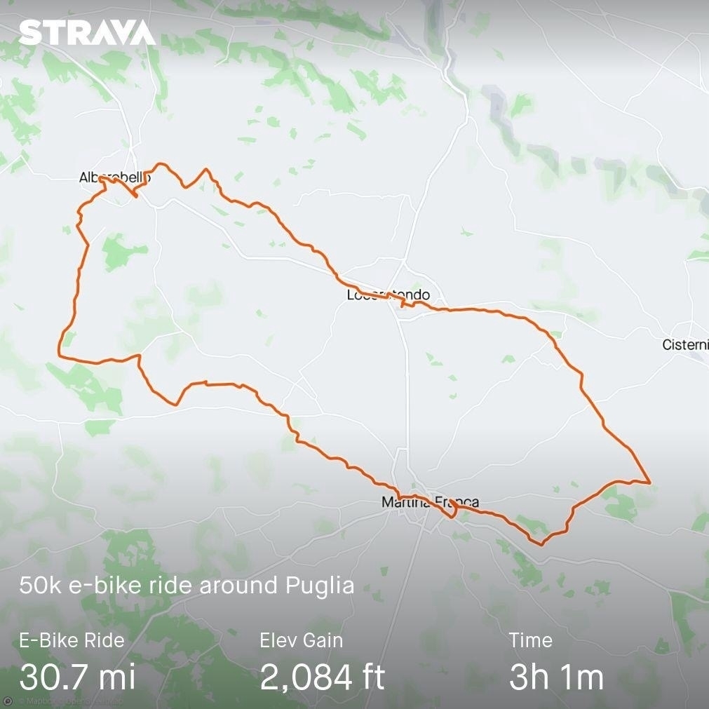Strava map showing a 50-kilometer e-bike ride route around Puglia, Italy. The route covers 30.7 miles with an elevation gain of 2,084 feet and a recorded time of 3 hours and 1 minute. 