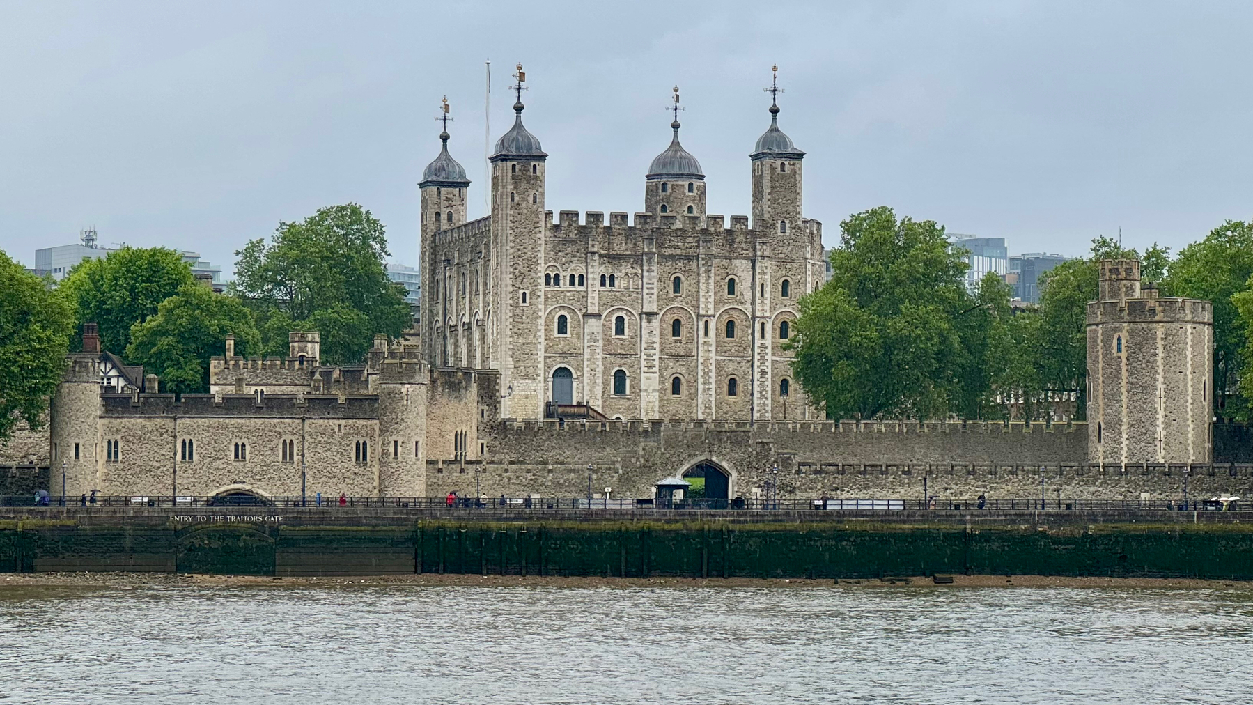 The Tower of London, a historic castle on the north bank of the River Thames in central London, with its distinctive white buildings and four turreted towers.