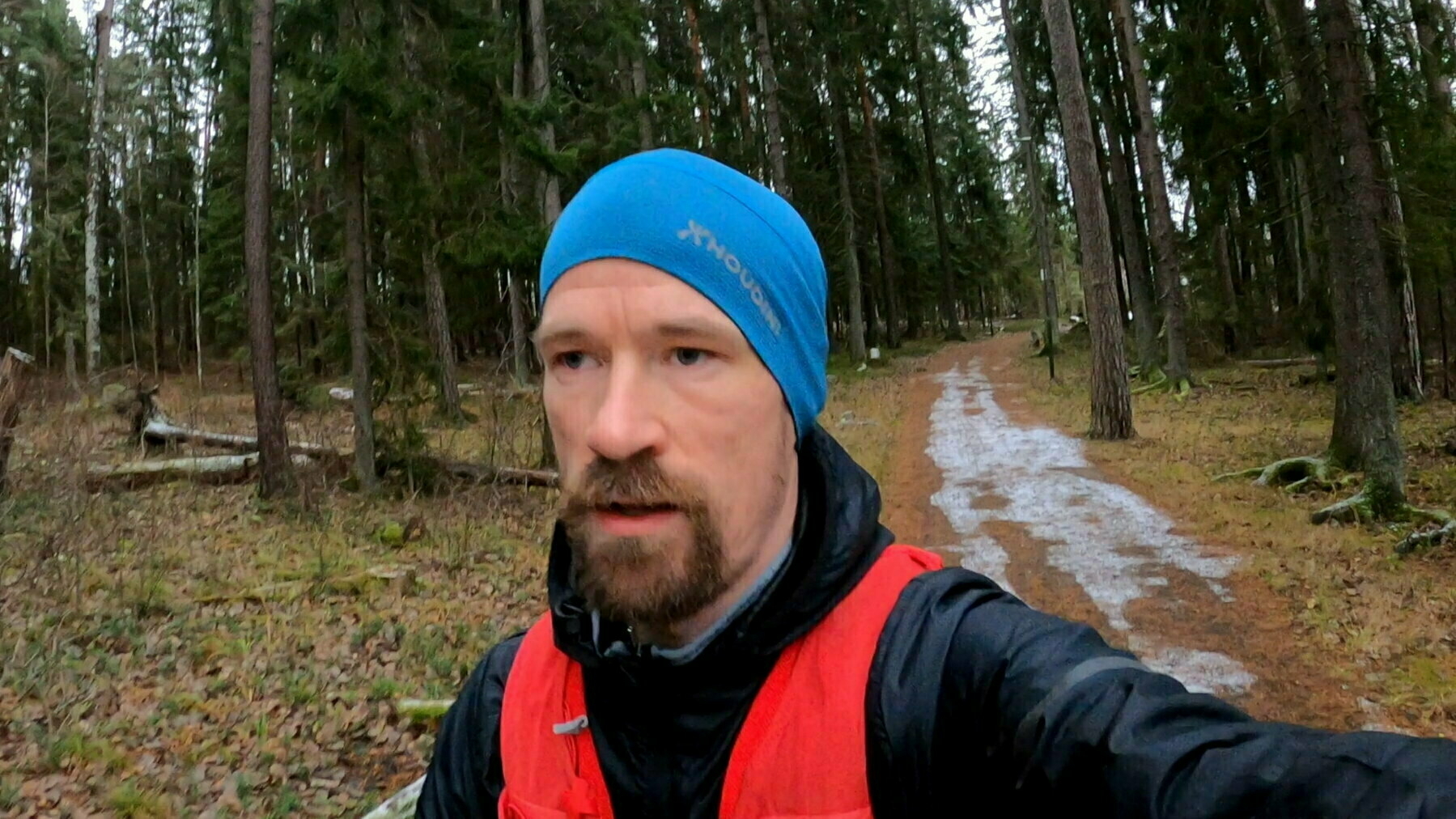 Me running on a trail with a little snow.