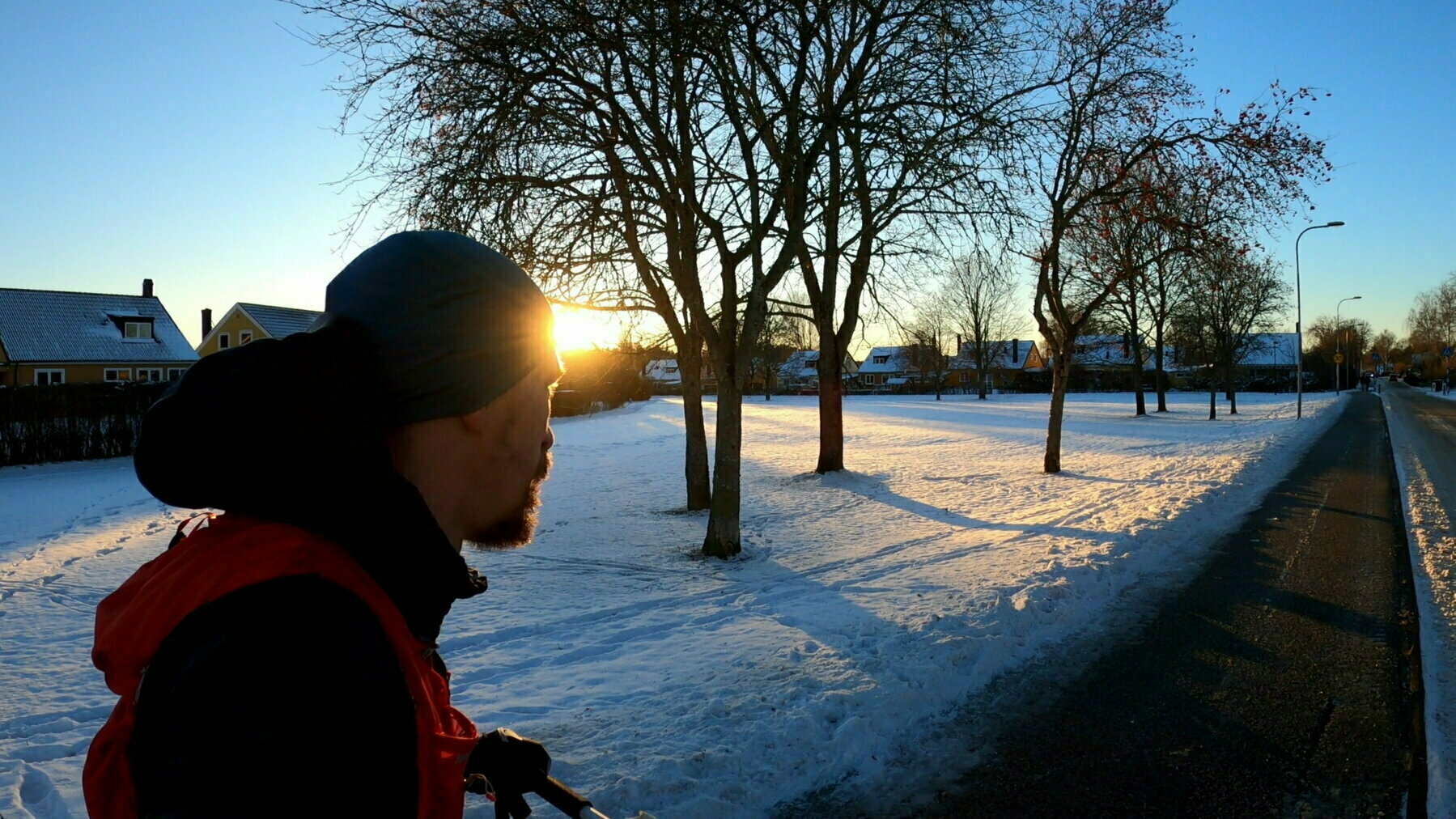 Me running in a snow-covered landscape with the sun setting in the background.