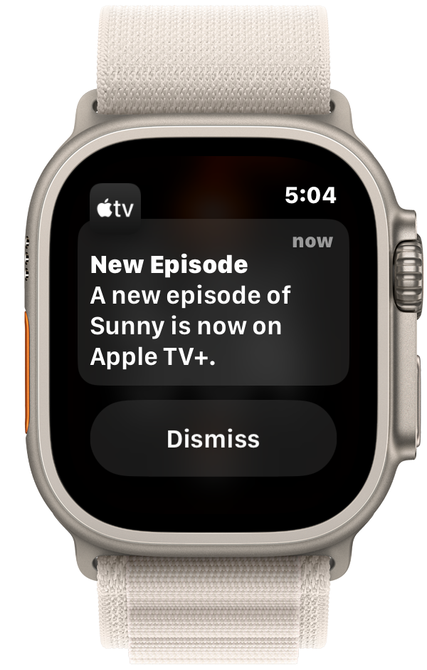 The image shows a notification on an Apple Watch screen. The notification, from the Apple TV app, states that a new episode of the show “Sunny” is now available on Apple TV+. The screen displays the current time as 5:04,