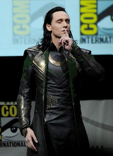 Tom Hiddleston, dressed as Loki, shushes the crowd in Hall H at San Diego Comic*Con. 