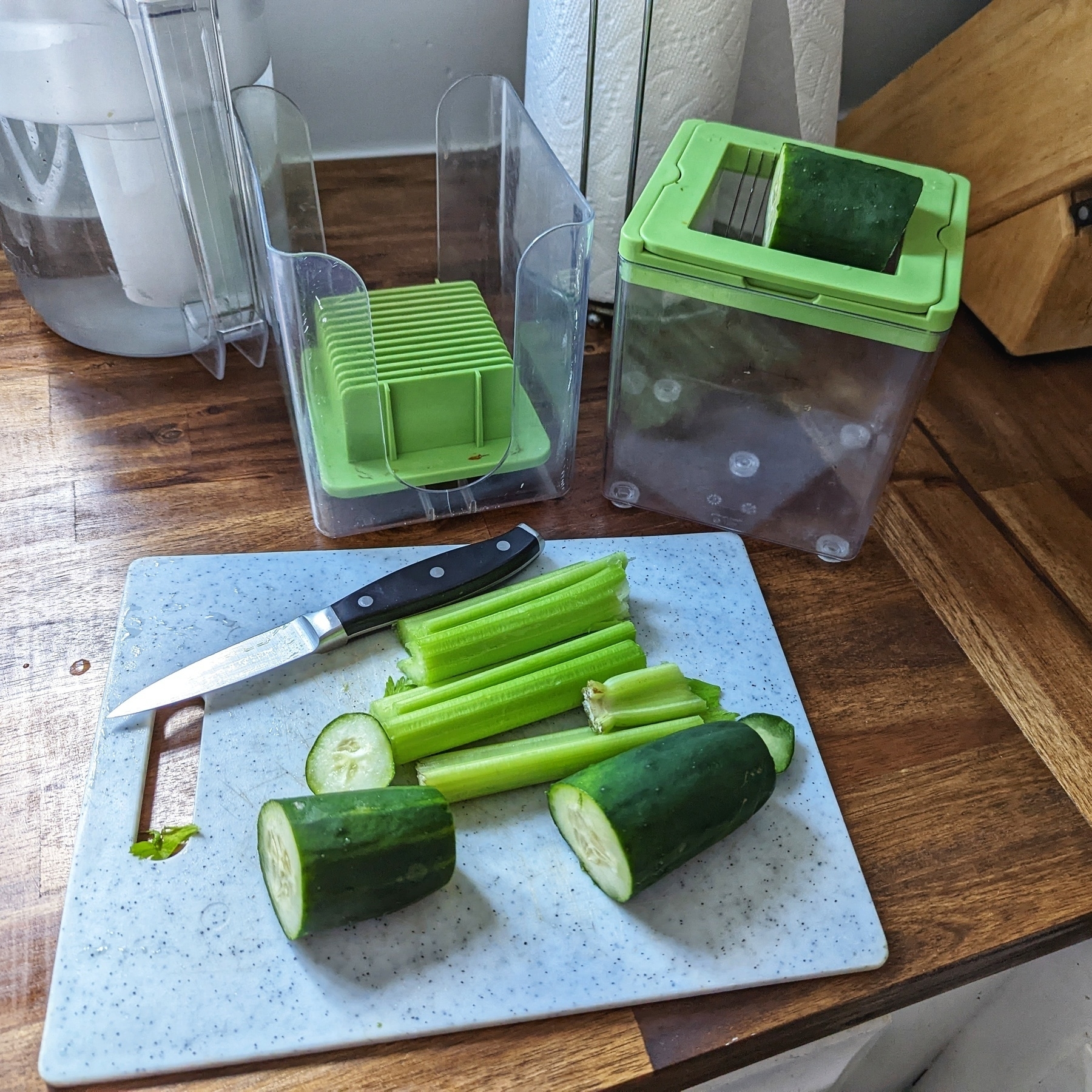 Celery and cucumber on a cutting board before slicing