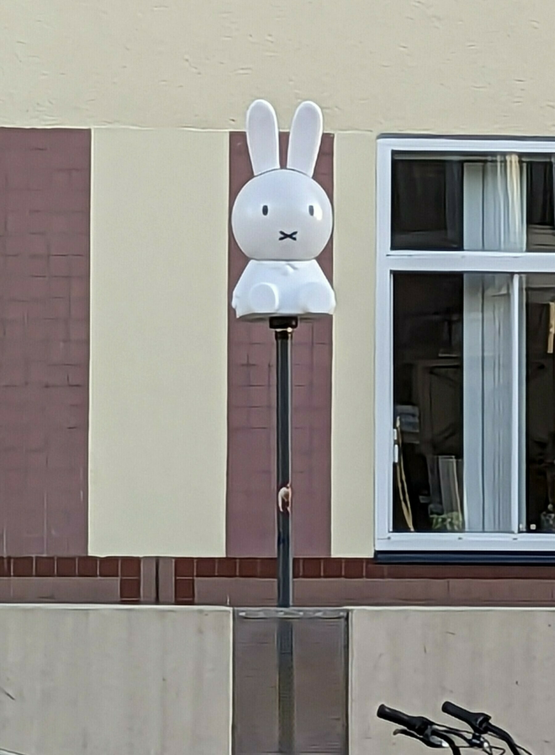 A street lamp that has been decorated to look like Nijntje (known as Miffy in English).