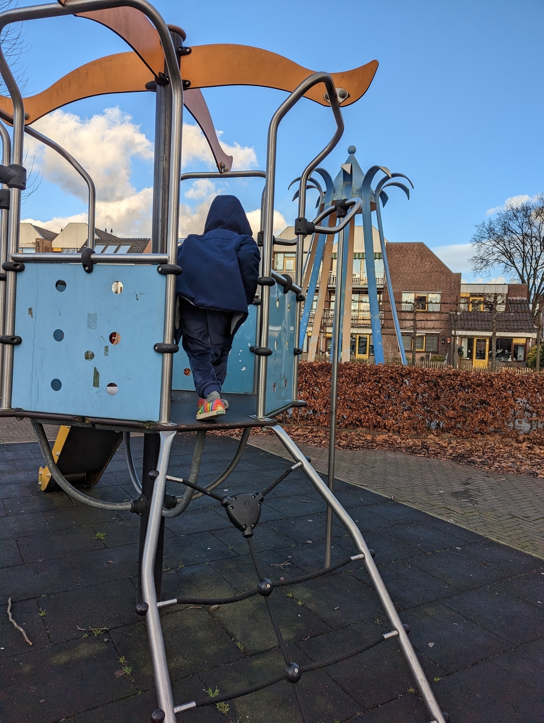 A child plays on a small playground.