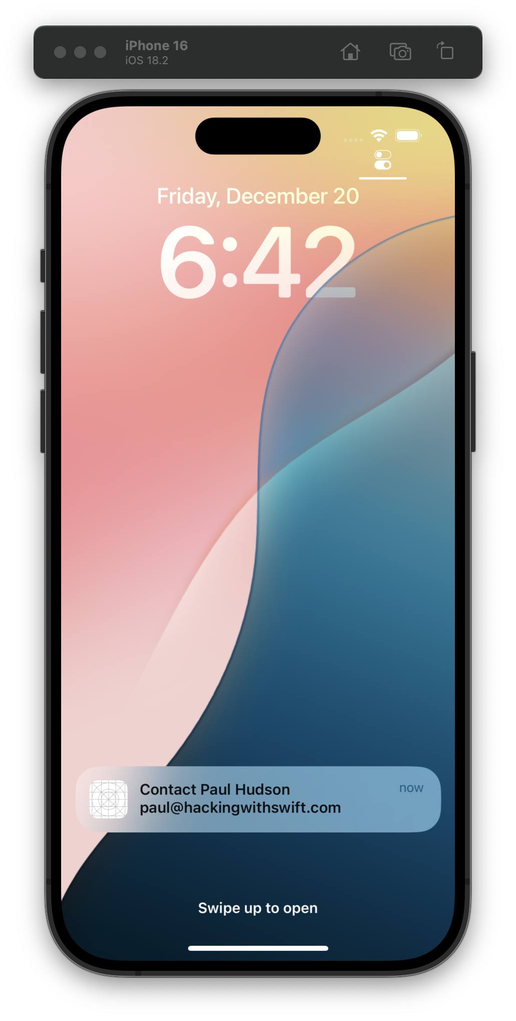 The iOS Simulator displays a lock screen with the date Friday, December 20, the time 6:42, and a notification labeled Contact Paul Hudson with an email address. The background shows a gradient of soft pink and blue hues.