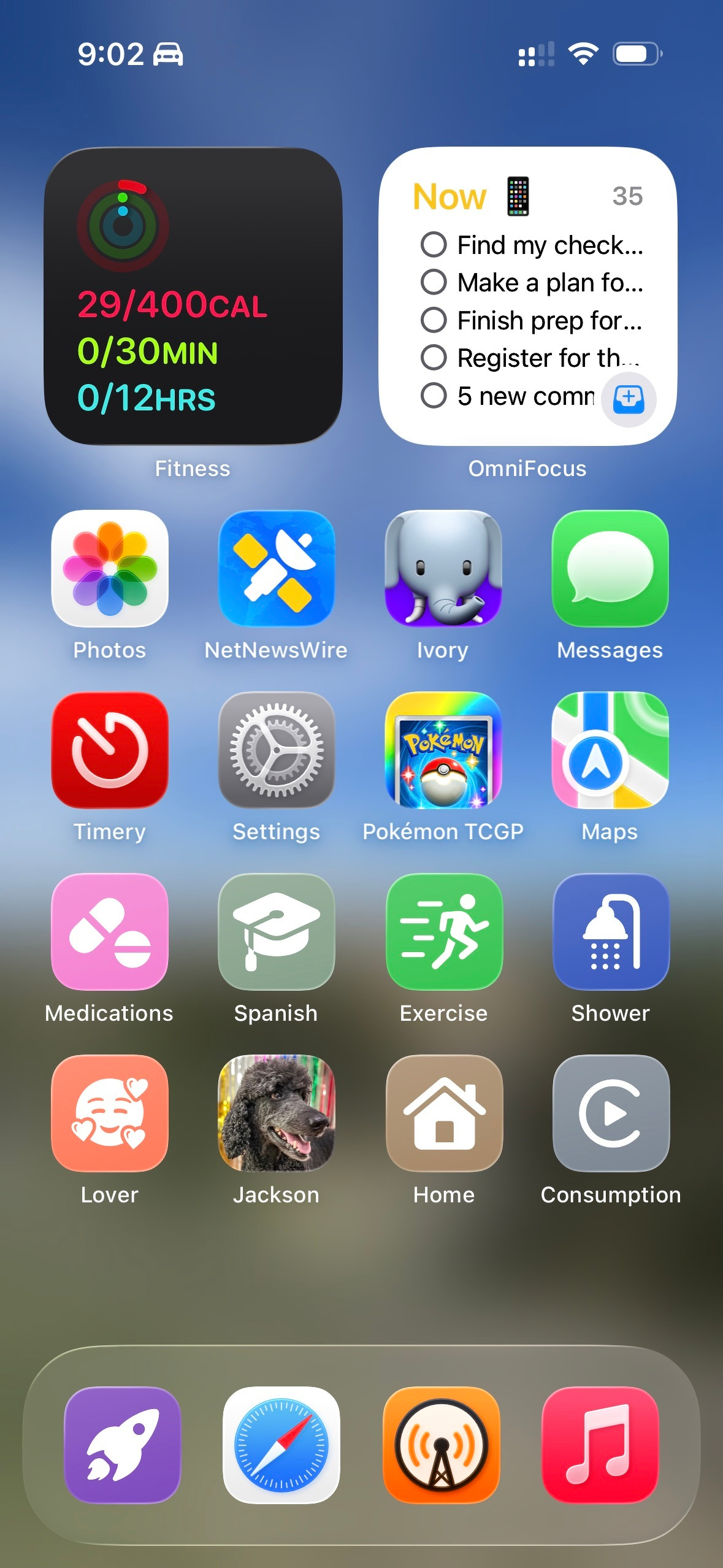 An iOS home screen (in Small icon mode with labels under the icons) showing blurred photo in the background. The first row has Fitness and OmniFocus widgets. The second and third rows are a mix of app icons from the Siri Suggestion widget. The fourth row has Medications, Stretch, Exercise, and Shower shortcuts. The fifth row has Lover, Jackson, Home, and Consumption shortcuts. The dock at the bottom has a personal shortcuts launcher, Safari, Overcast, and Music.