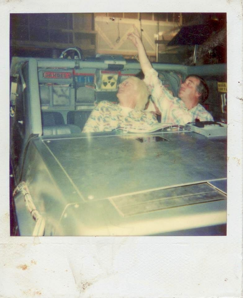 Terry Winnick and Christopher Lloyd in the DeLorean on the Back to the Future: The Ride set