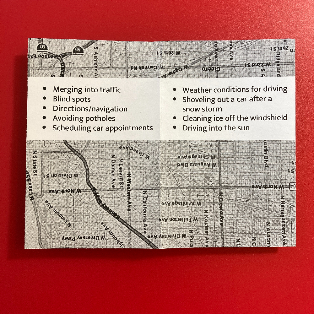 A paper with a printed list of driving-related tasks and challenges.