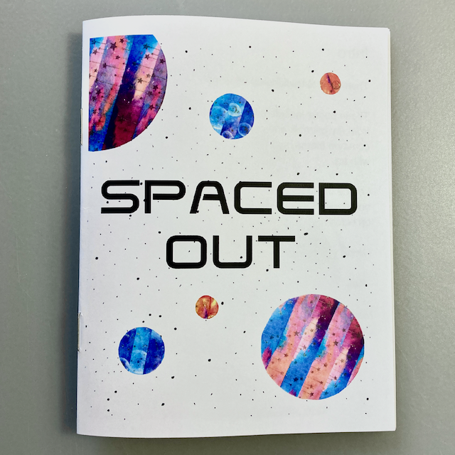 The cover of a zine titled SPACED OUT with colorful, abstract planets and a starry background.