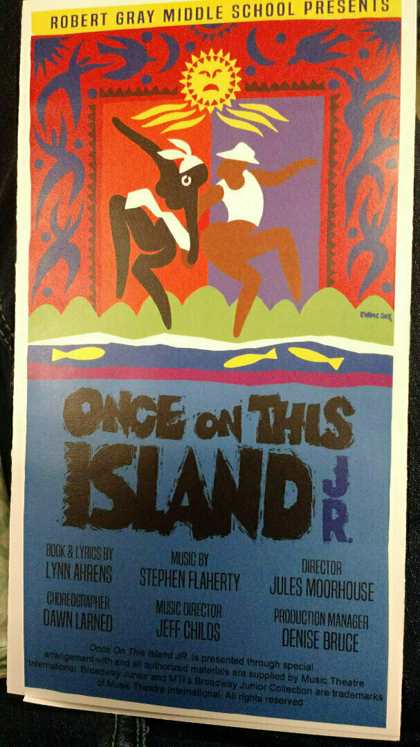 A colorful poster advertises Robert Gray Middle School's production of Once on This Island Jr. with a vibrant illustration and production details.