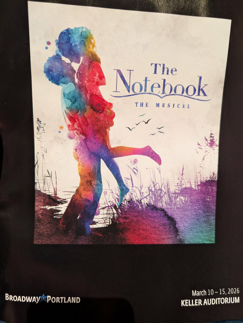 A vibrant, colorful poster for The Notebook: The Musical features a silhouette of a couple embracing against a watercolor background, with details about a performance at Keller Auditorium in March 2026.