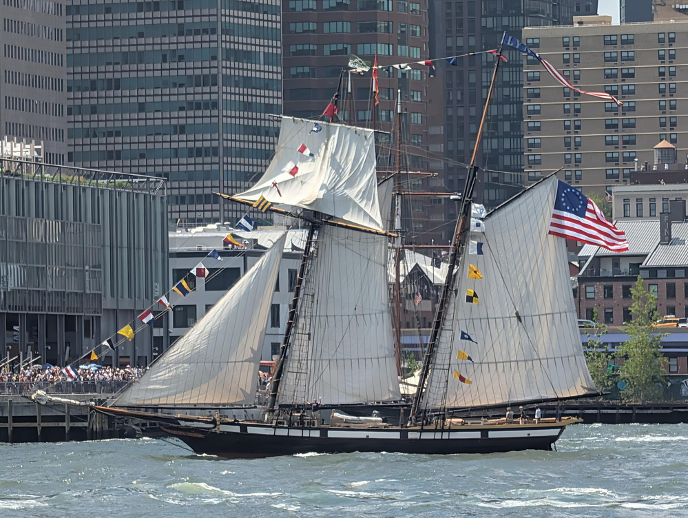 My daughter is standing on the rail of the Lynx waving as they past by us. They are sailing in the East River as part of the Sail 250 events. This was the small ship parade on July 3, 2026.