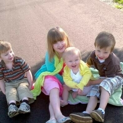 My four small kids sitting outside on a sunny day. Photo taken 2012