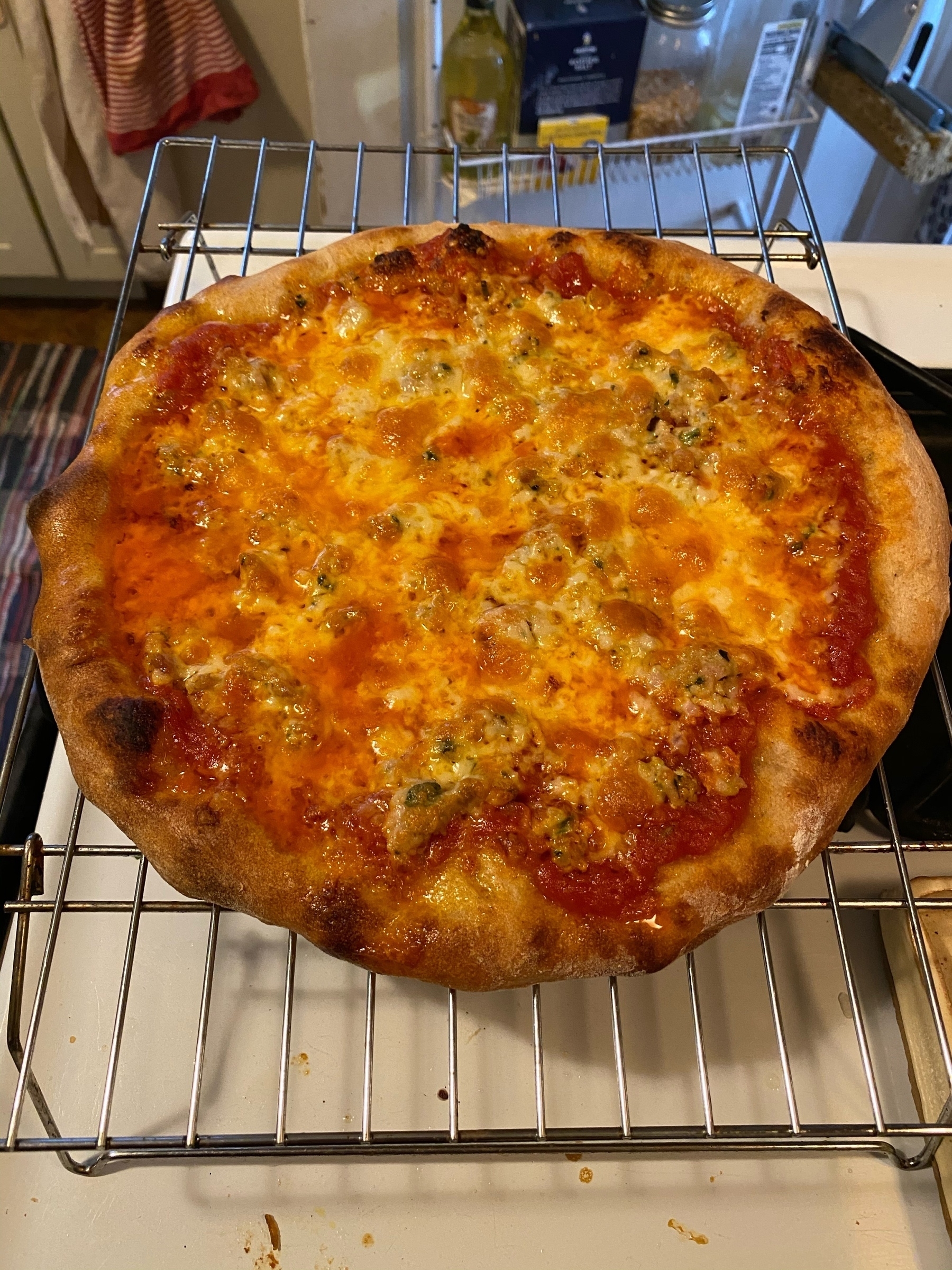 Another small pizza on a cooling rack.