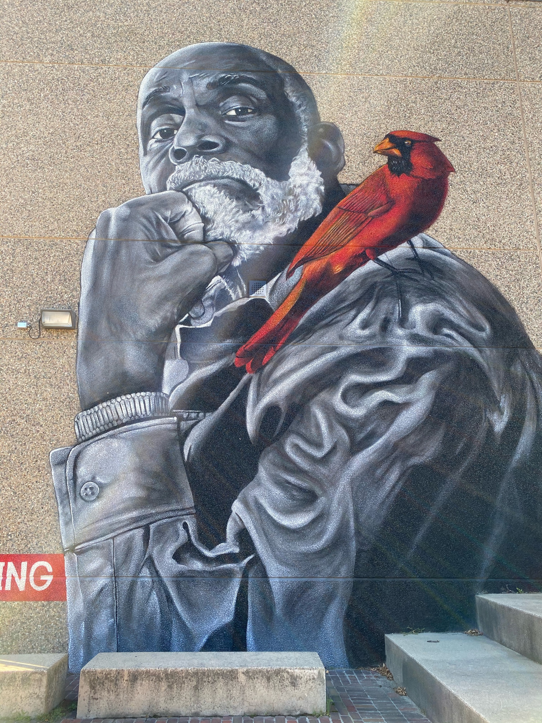 Mural of Mel King with a cardinal on his shoulder.