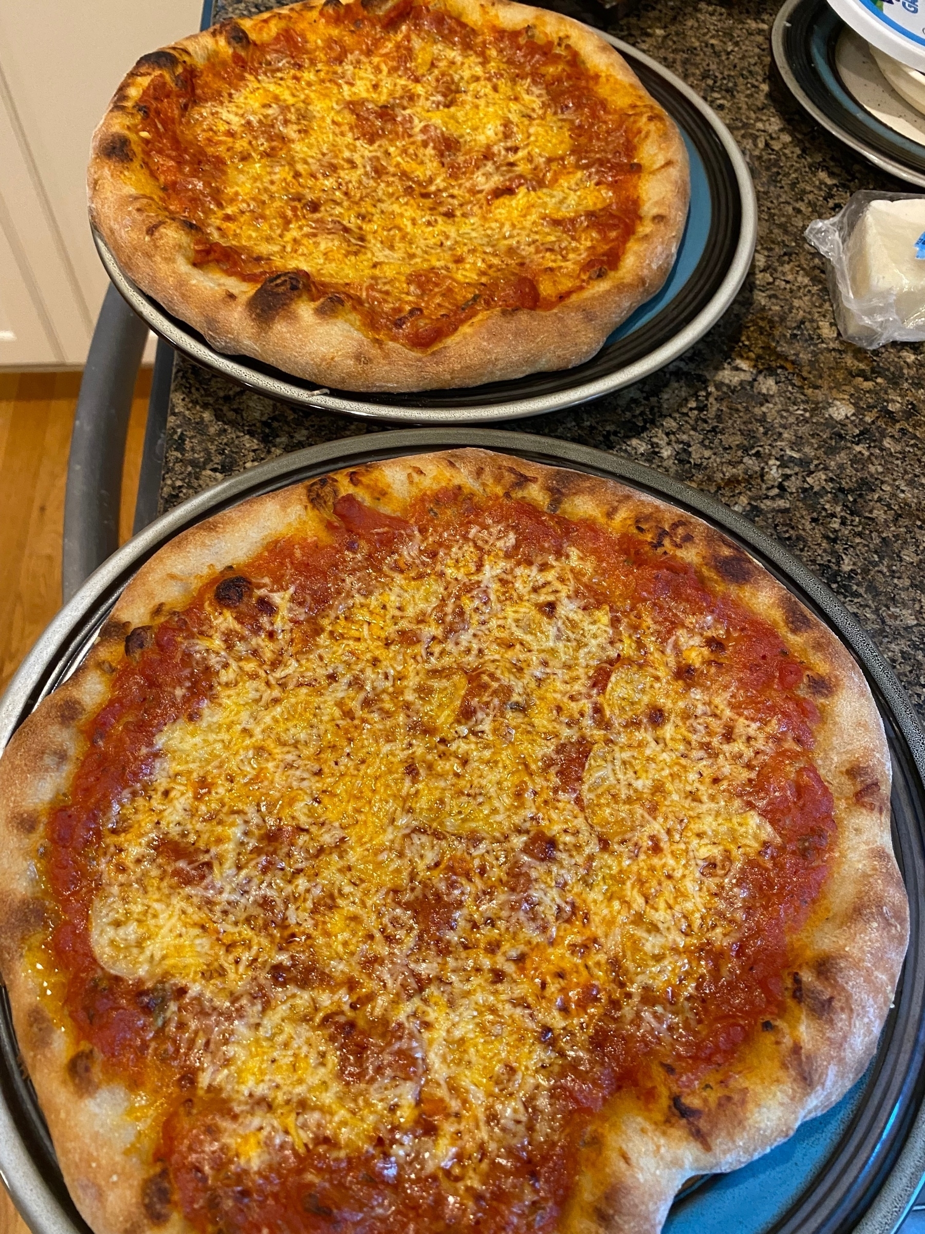 Two small pizzas on blue plates.