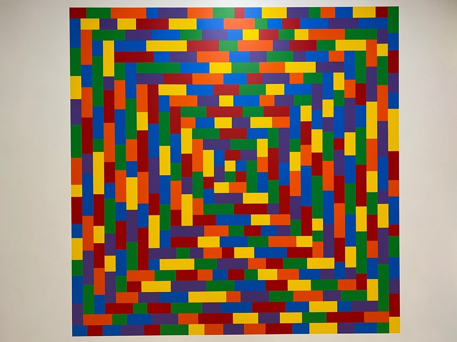 Painting of many brightly colored rectangles in a rectangular arrangement.