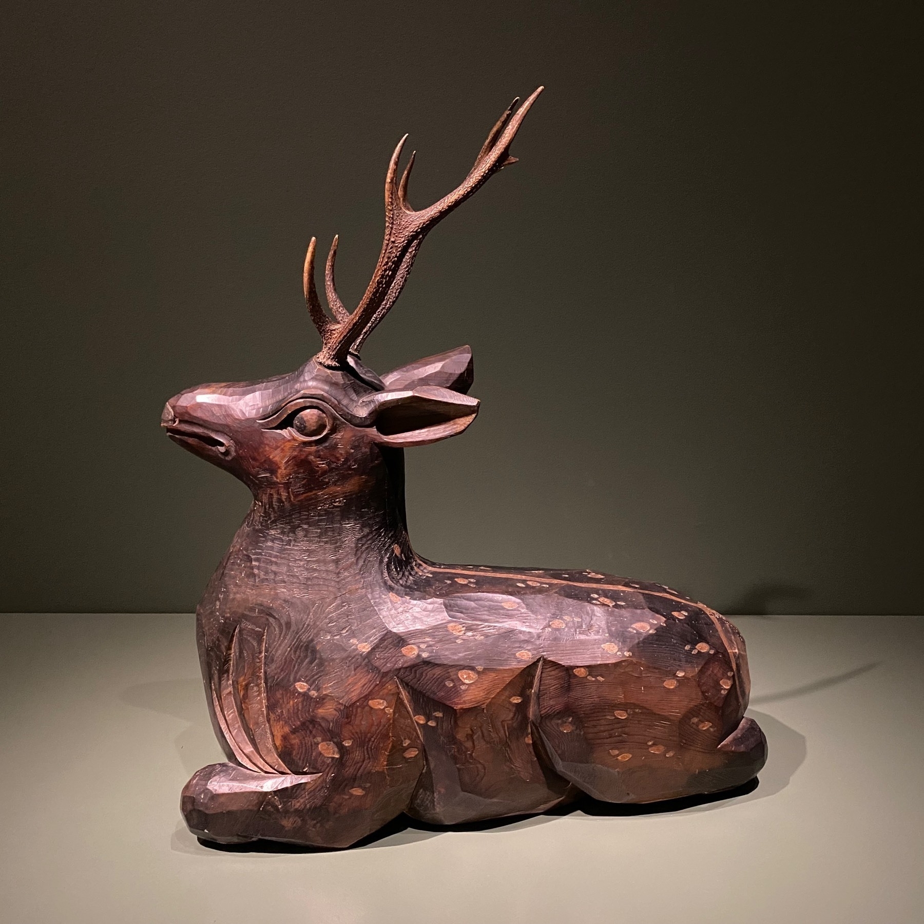 Wood sculpture of a deer.