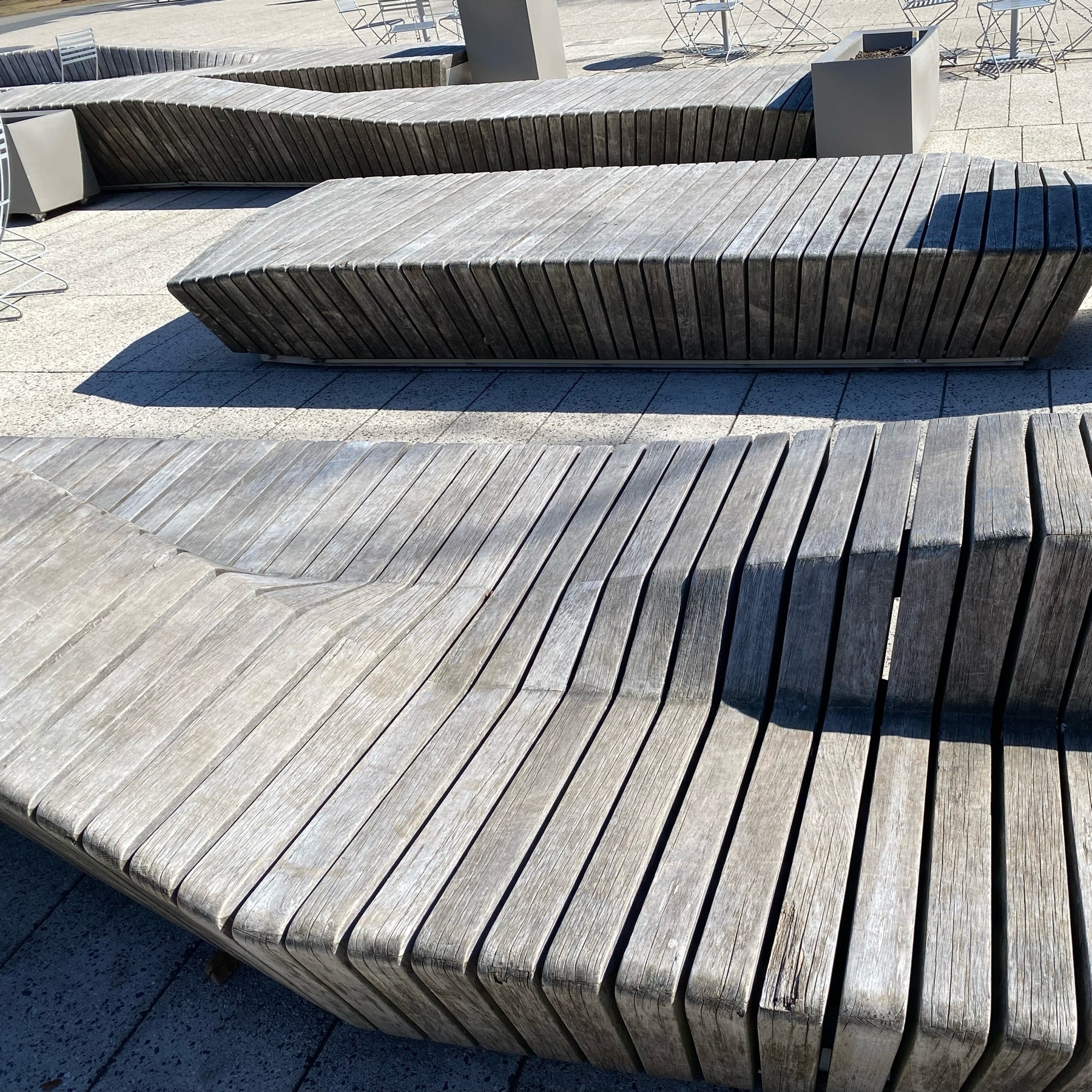 Wooden benches with curved slats.