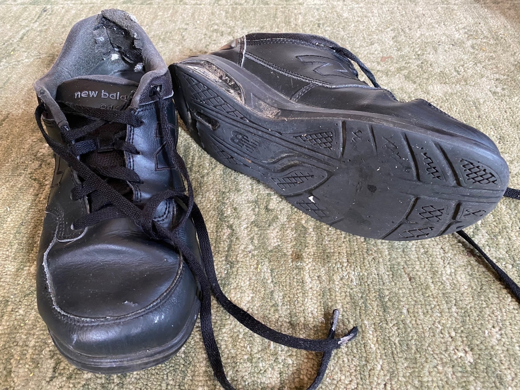 Pair of fairly worn black walking shoes.